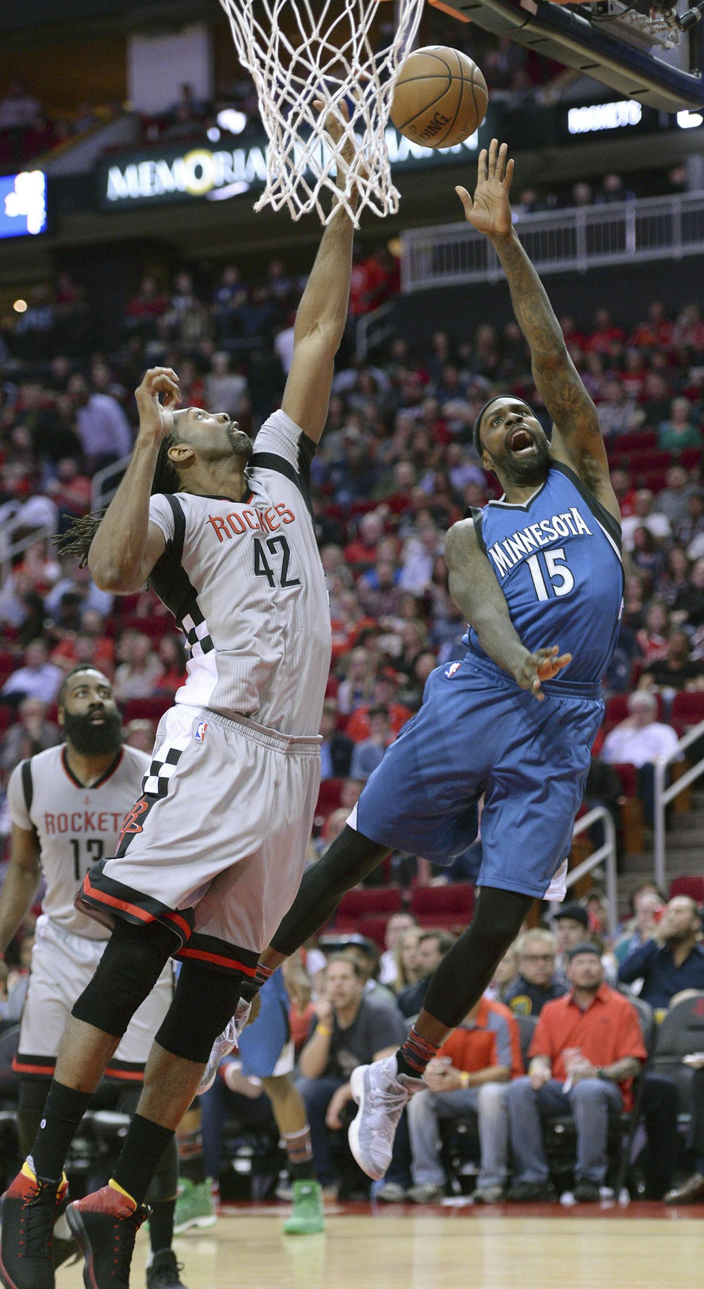 Minnesota Timberwolves forward Shabazz Muhammad (15) shoots against Houston Rockets center Nene (42) in the first half of an NBA basketball game Saturday, Feb. 25, 2017, in Houston. (AP Photo/George Bridges) ORG XMIT: MIN2017022521251024