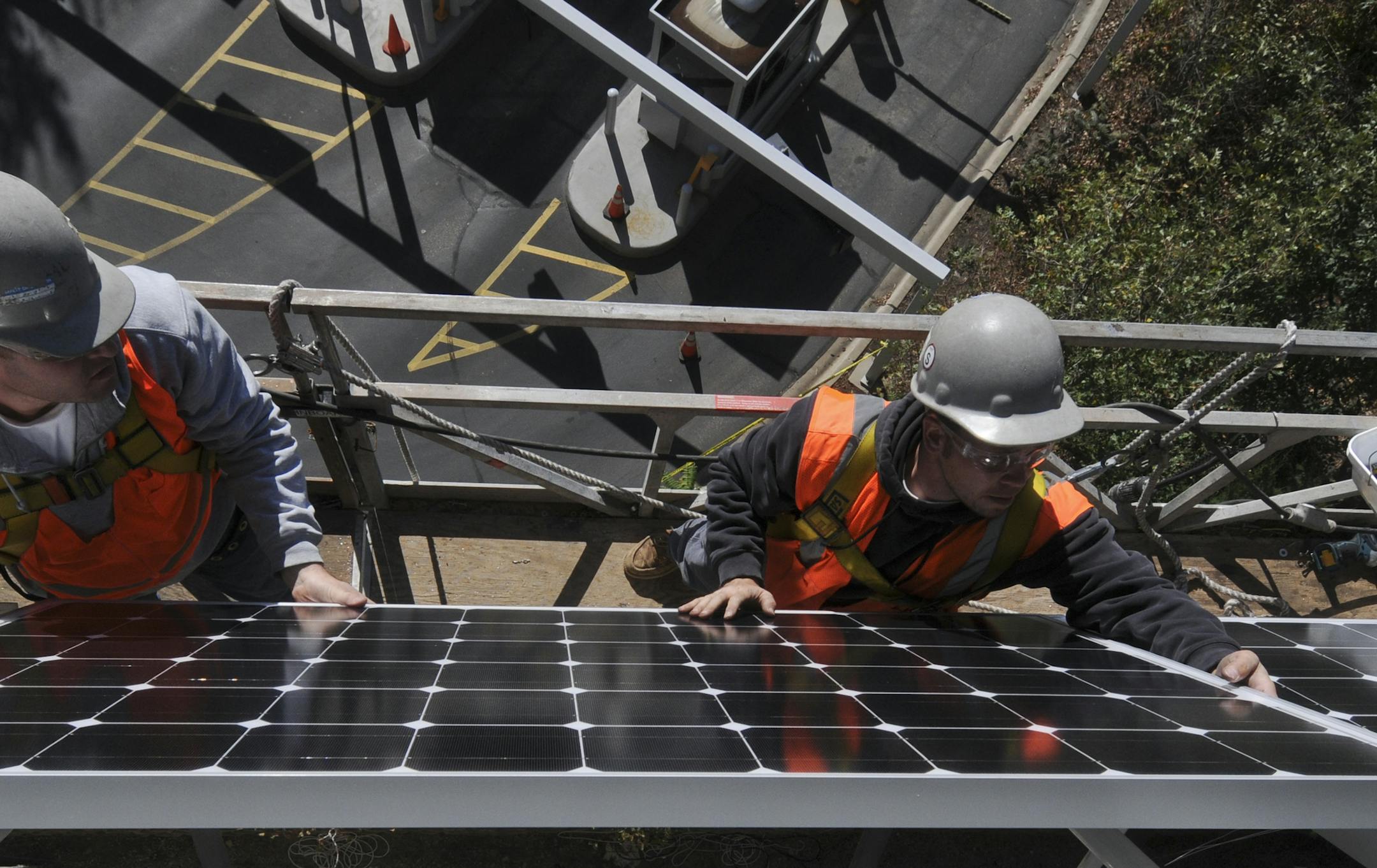 Workers installed solar panels on the side of the St. Paul RiverCentre Parking Ramp in 2011.
