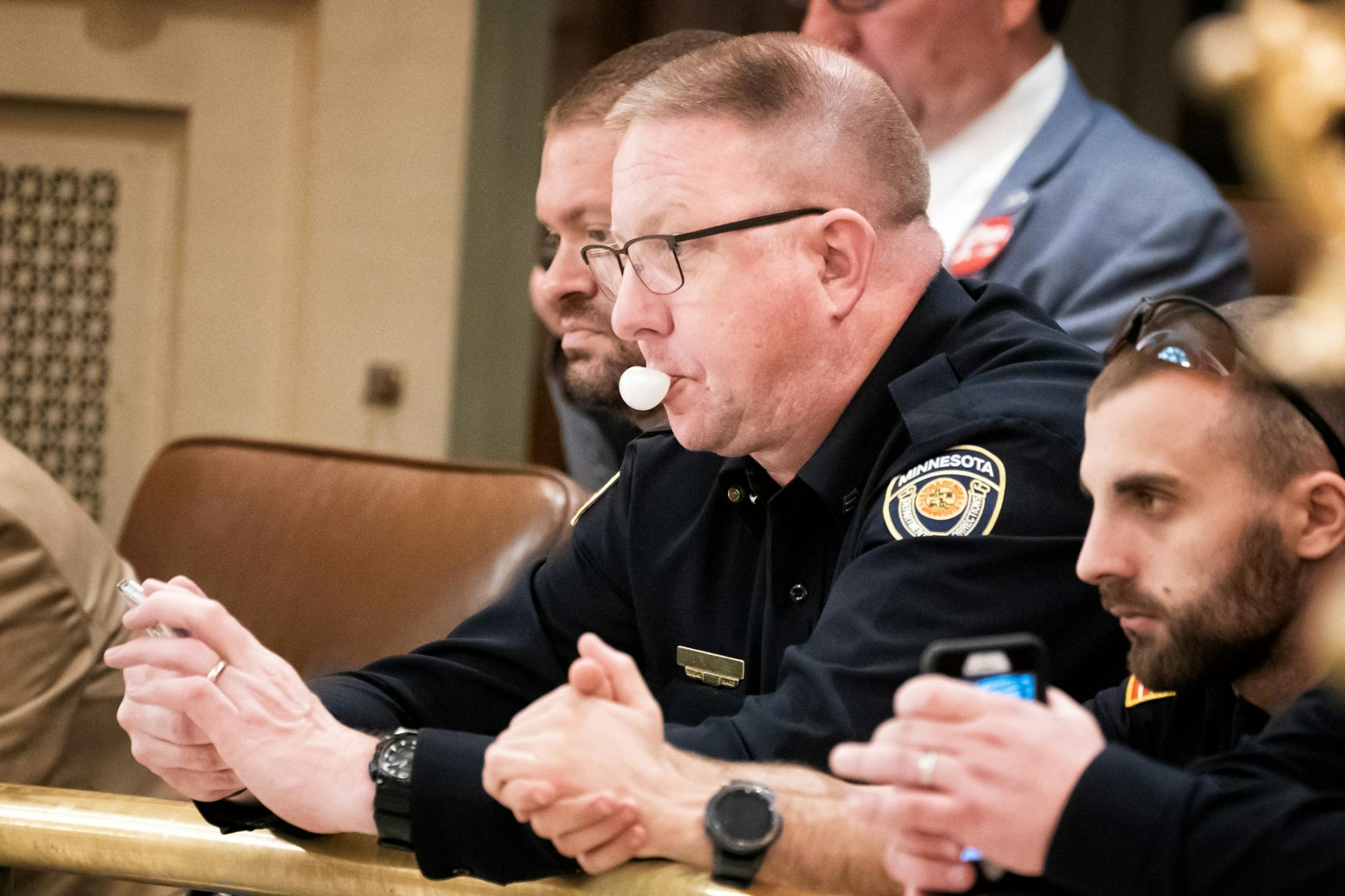 Minnesota Corrections Sgt. Rick Neyssen, blew bubbles in the House Gallery as legislators debated the omnibus education bill. He was there with other officers in his role as part of AFSCME, the American Federation of State and County Municipal Employees, He waited to talk with legislators during a break.