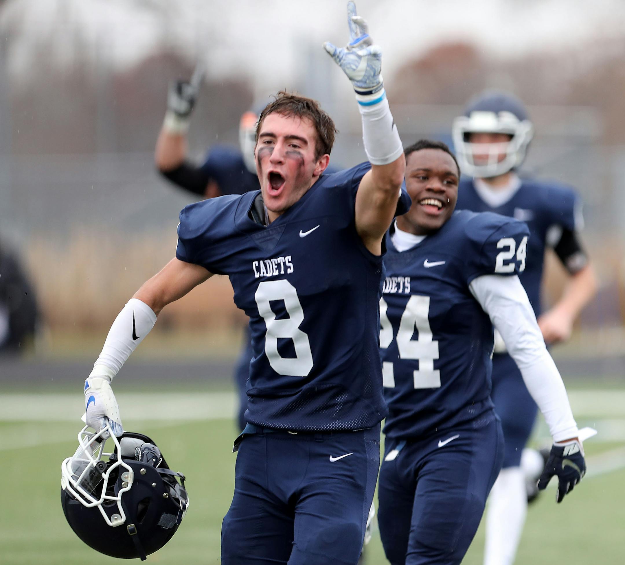 St. Thomas Academy's Stephen Betts (8) and Love Adebayo (24) celebrate after their 21-0 win over Owatonna.] DAVID JOLES • david.joles@startribune.com Class 5A football state quarterfinal, Owatonna vs. St. Thomas Academy, rematch of Class 5A Prep Bowl Saturday, Nov. 9, 2019 at Woodbury High in Woodbury, MN.