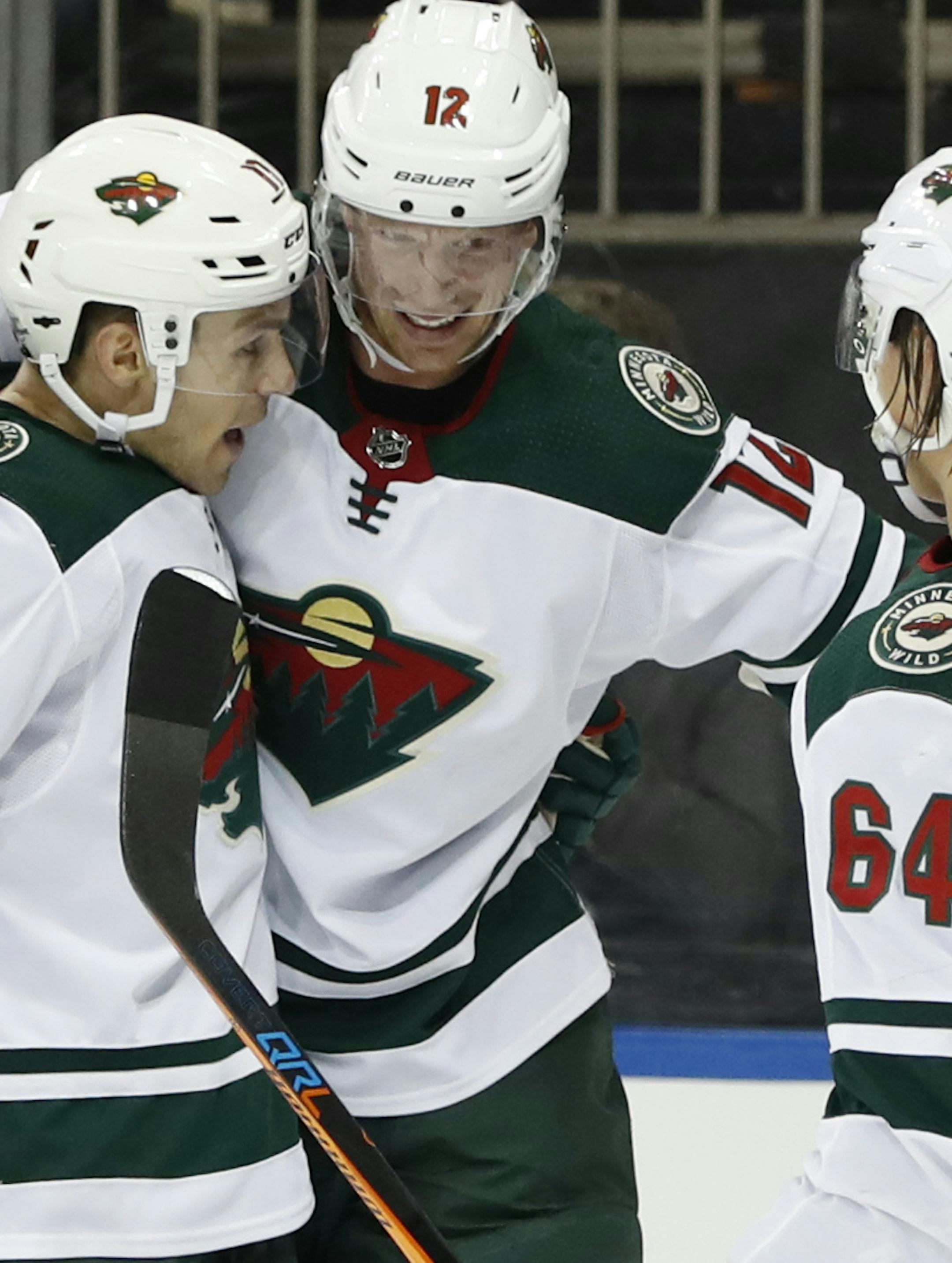 Minnesota Wild left wing Zach Parise (11), center Eric Staal (12), and right wing Mikael Granlund (64) celebrate after Granlund scored a goal during the first period of an NHL hockey game against the New York Rangers in New York, Friday, Feb. 23, 2018. (AP Photo/Kathy Willens)
