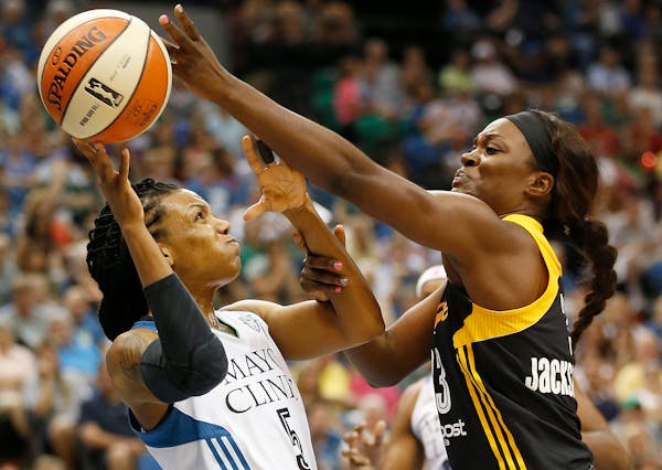 Minnesota Lynx guard Tan White (5) tries to pass the ball against Tulsa Shock forward Tiffany Jackson-Jones (33) in the first half of a WNBA basketbal