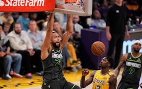 Timberwolves center Rudy Gobert dunks while Lakers forward Dorian Finney-Smith puts up little fight during the first half of Game 5 Wednesday.