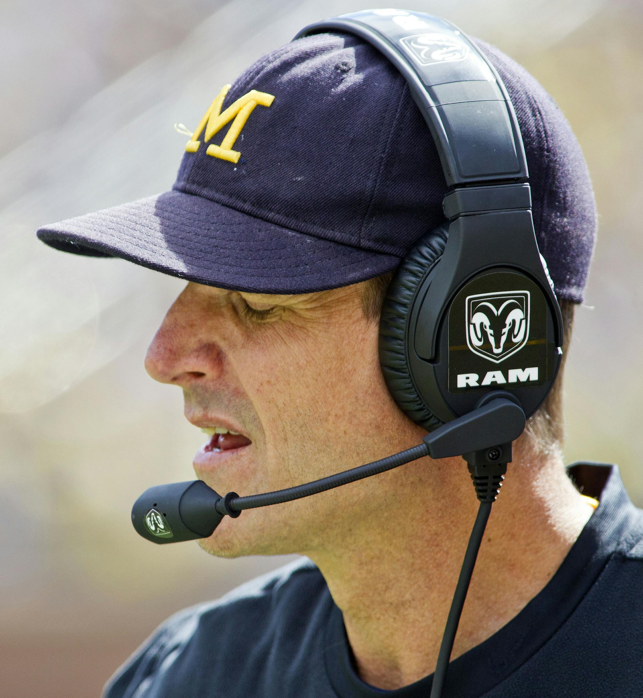 Michigan head coach Jim Harbaugh, wearing a headset, on the sidelines in the third quarter of an NCAA college football game against UNLV in Ann Arbor, Mich., Saturday, Sept. 19, 2015. Michigan won 28-7. (AP Photo/Tony Ding)