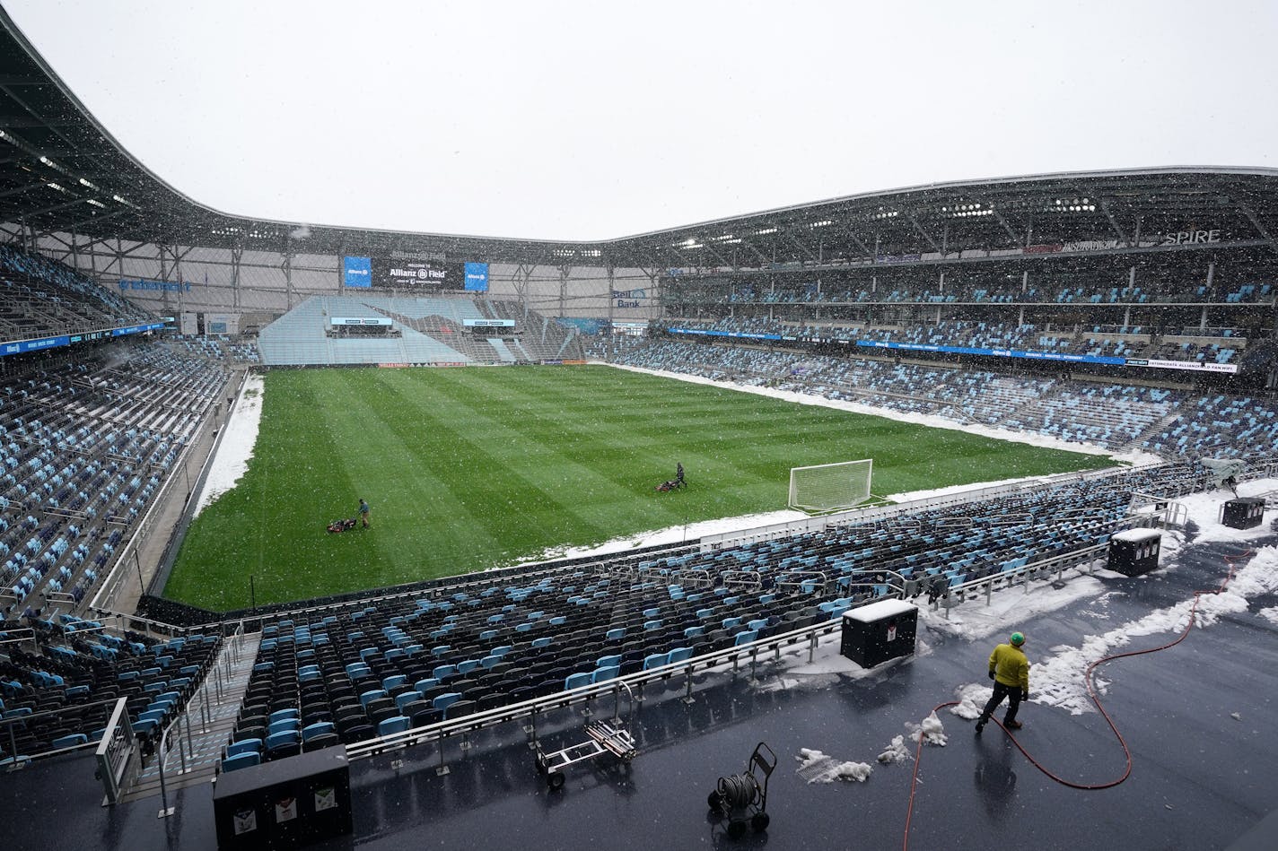 Members of the grounds crew cut the grass Friday at Allianz Field amid heavy snow flurries ahead of Saturday's home opener. ] ANTHONY SOUFFLE • anthony.souffle@startribune.com Crews cleared snow and ice as they readied Allianz Field for Saturday's home opener against the New York City Football Club Friday, April 12, 2019 in St. Paul, Minn.