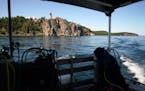 Split Rock Lighthouse is seen from the deck of a dive boat on Lake Superior. The PolyMet mine would sit in the Lake Superior watershed, meaning that p