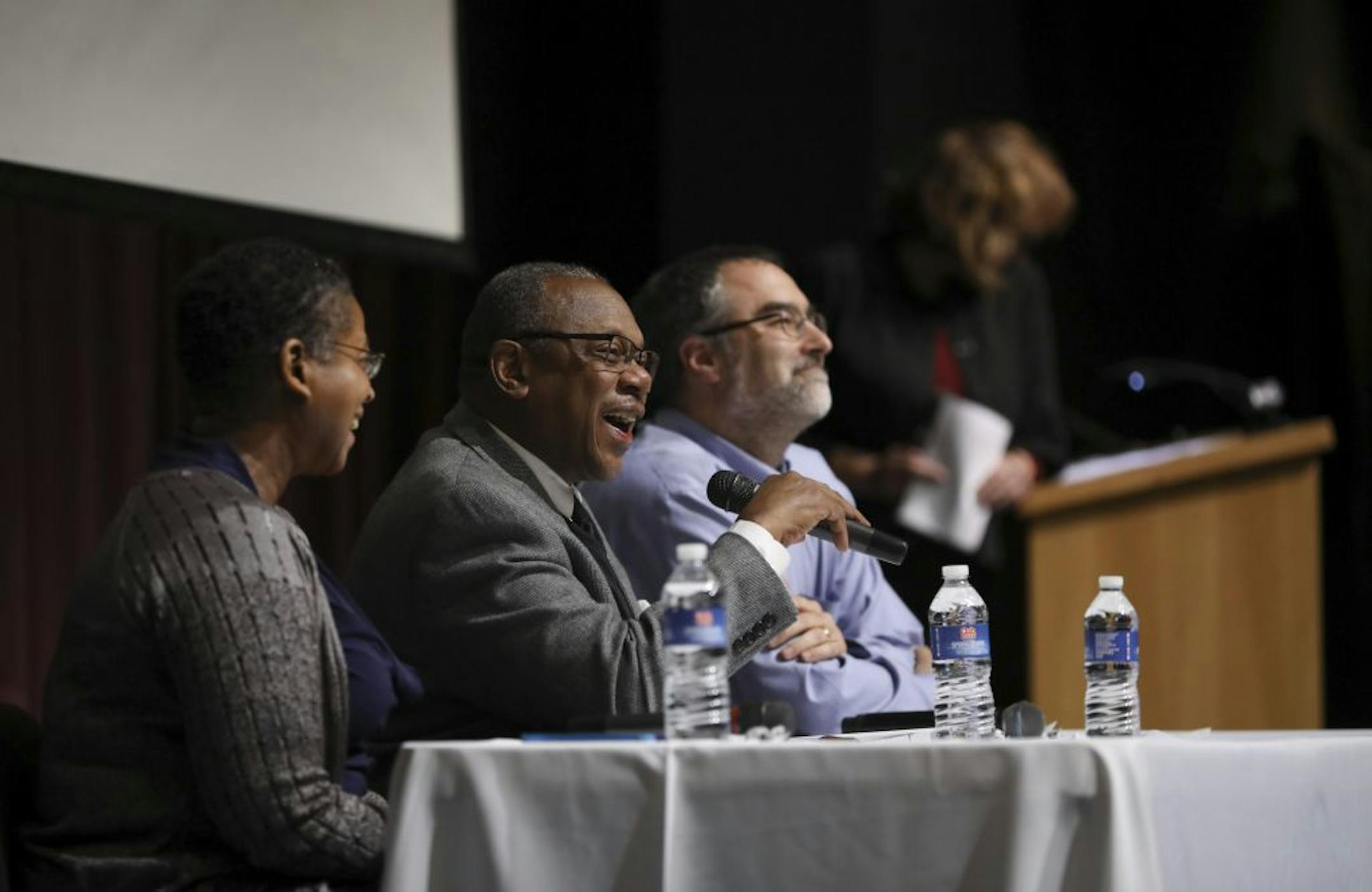 The panel was made up of Janice Downing, Henry Crosby, speaking, and Paul Spies, from left.