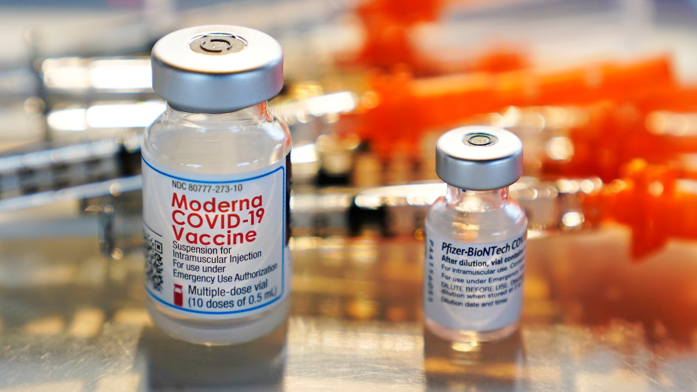 Vials for the Moderna and Pfizer COVID-19 vaccines, shown in February.