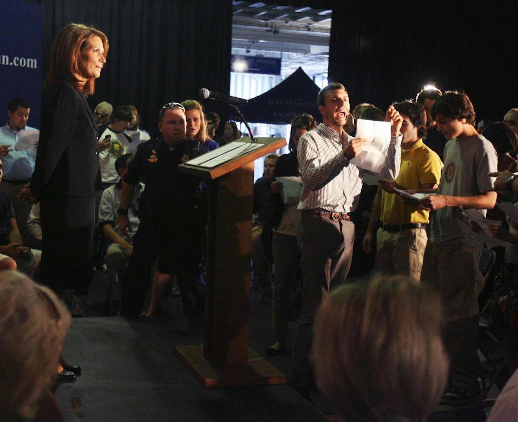 Republican presidential candidate Michele Bachmann pauses as Occupy Wall Street protestors interrupt her foreign policy speech on the USS Yorktown in Mt. Pleasant, S.C., near Charleston, Thursday, Nov. 10, 2011.