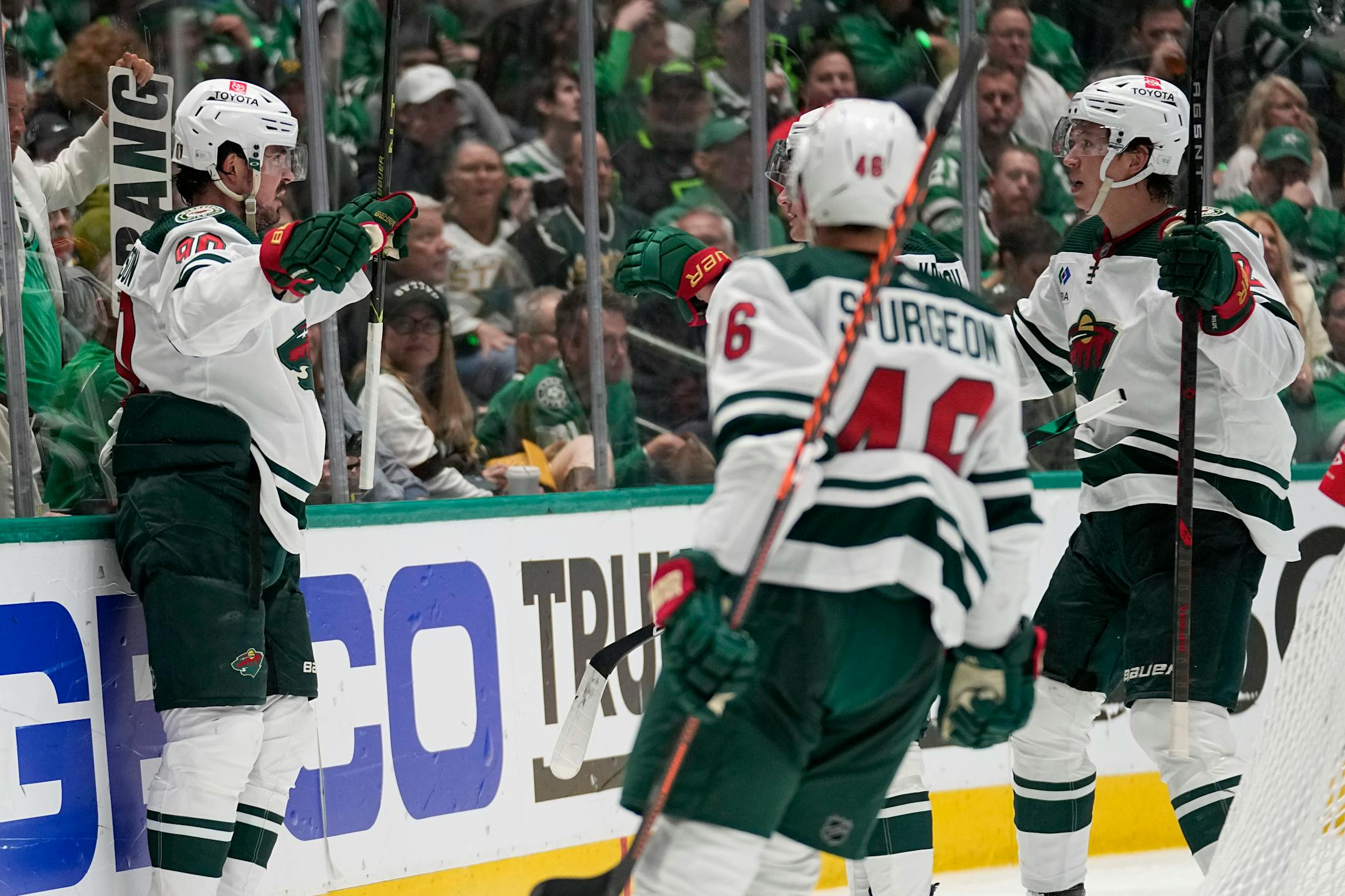 Minnesota Wild left wing Marcus Johansson, left, Jared Spurgeon (46) and Matt Boldy, right, celebrate after Johansson scored in the second period of Game 2.