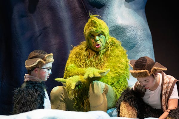 Reed Sigmund, playing the Grinch, chats with Matthew Woody and Audrey Mojica, left to right, child actors playing young Max, during a break on set Thu