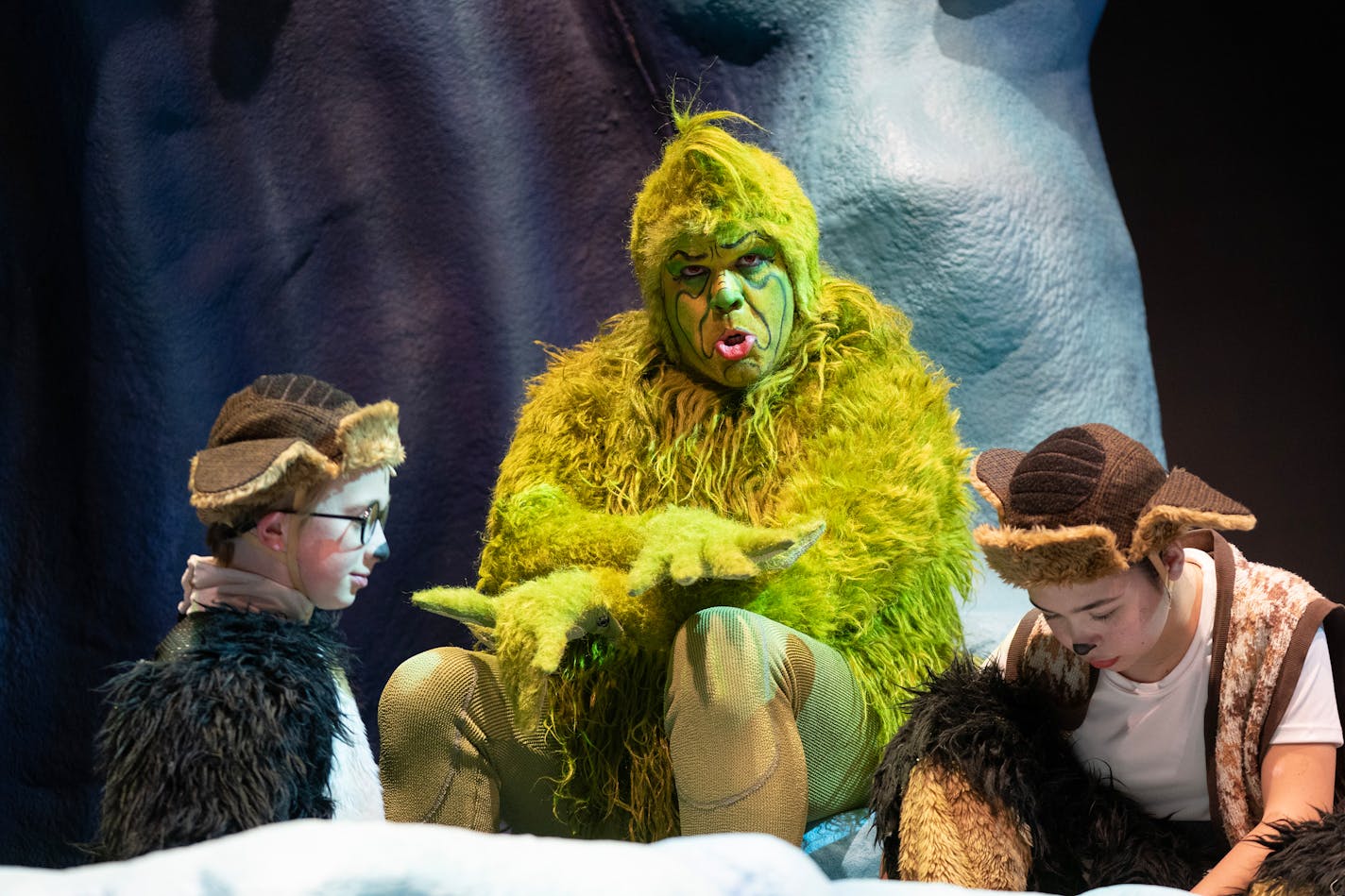 Reed Sigmund, playing the Grinch, chats with Matthew Woody and Audrey Mojica, left to right, child actors playing young Max, during a break on set Thursday, Nov. 02, 2023, at the Children's Theatre in Minneapolis, Minn. ]