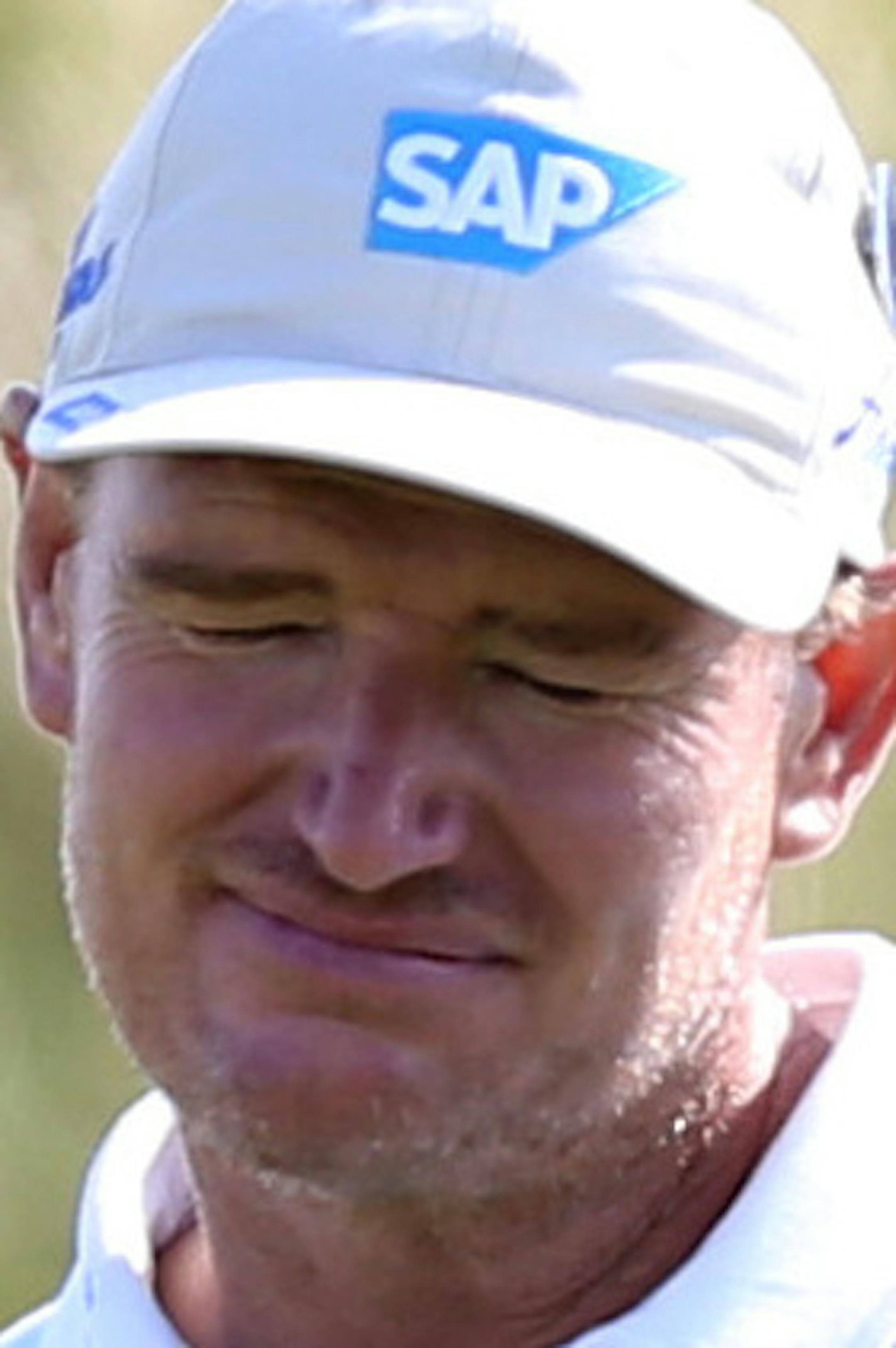 Ernie Els of South Africa grimaces after a putt on the 12th green during the first day of the British Open Golf championship at the Royal Liverpool golf club, Hoylake, England, Thursday July 17, 2014. (AP Photo/Scott Heppell)