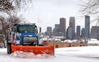 City of Minneapolis truck driver Vicky Stich plows snow and lays down sand and salt on Olson Highway Service Road in Minneapolis on Tuesday, November 