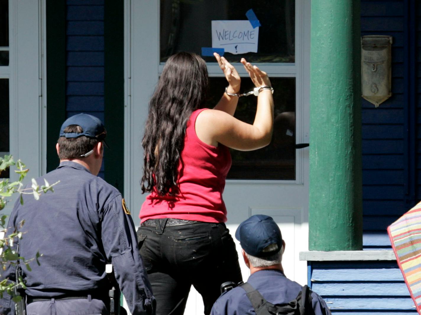 St. Paul police officers attempted to enter a house on Iglehart Ave. Saturday. Sara Coffey of the National Lawyers Guild was stopped outside the house, handcuffed and detained. She helped police negotiate with those inside.