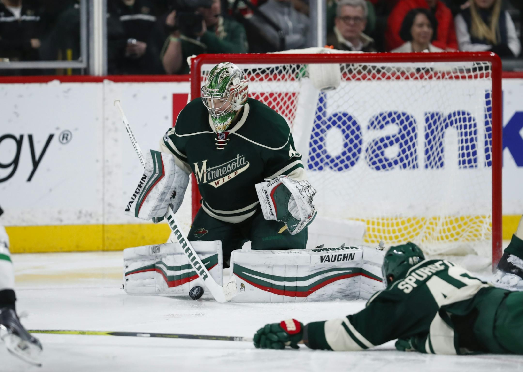 Minnesota Wild goalie Darcy Kuemper (35) made a third period save while Wild defenseman Jared Spurgeon (46) dove to try to block the shot.