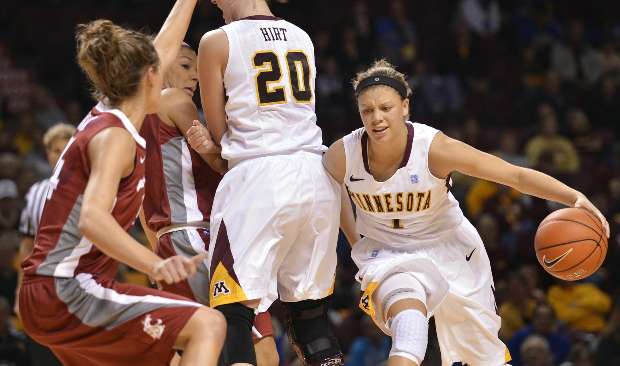 Minnesota's Kayla Hirt (center) sets a pick on Washington State defense for Rachel Banham (right) during the first half of the Gophers' season opener Saturday afternoon at Williams Arena.