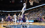 Minneapolis North guard Tyler Johnson (10) dunked the ball off an alley oop pass in the first half against Goodhue Saturday. ] (AARON LAVINSKY/STAR TR