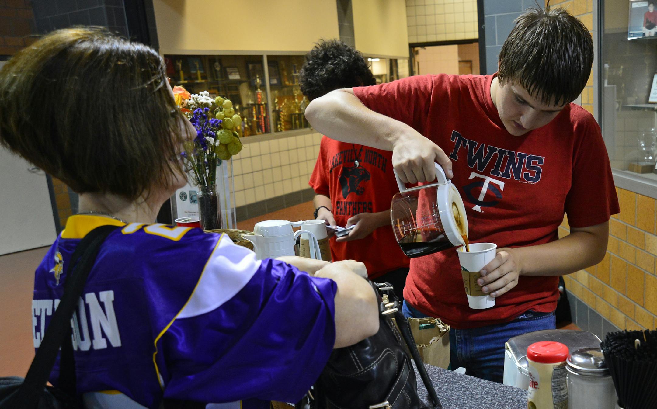 Lakeville North High School is creating a new cyber cafe, featuring Starbucks products, serving coffee, tea and other basic drinks. They're remodeling an area near the cafeteria to accommodate it and added outlets and seating. Lucas Ince worked behind the counter serving coffee to students and faculty before school.] Richard.Sennott@startribune.com Richard Sennott/Star Tribune Lakeville Minnesota Wednesday 9/17/13) ** (cq)