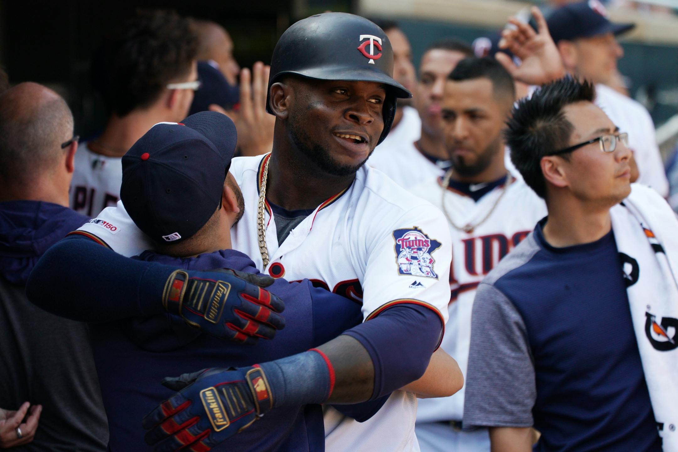Minnesota Twins third baseman Miguel Sano (22) celebrated with Twins communications assistant and Spanish interpreter Elvis Martinez in the dugout after he hit a three run home run in the ninth inning.
