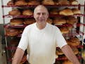 David Leventhal posed in 2002 in front of racks of challah at Cecil’s Delicatessen in St. Paul.