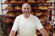 David Leventhal posed in 2002 in front of racks of challah at Cecil’s Delicatessen in St. Paul.