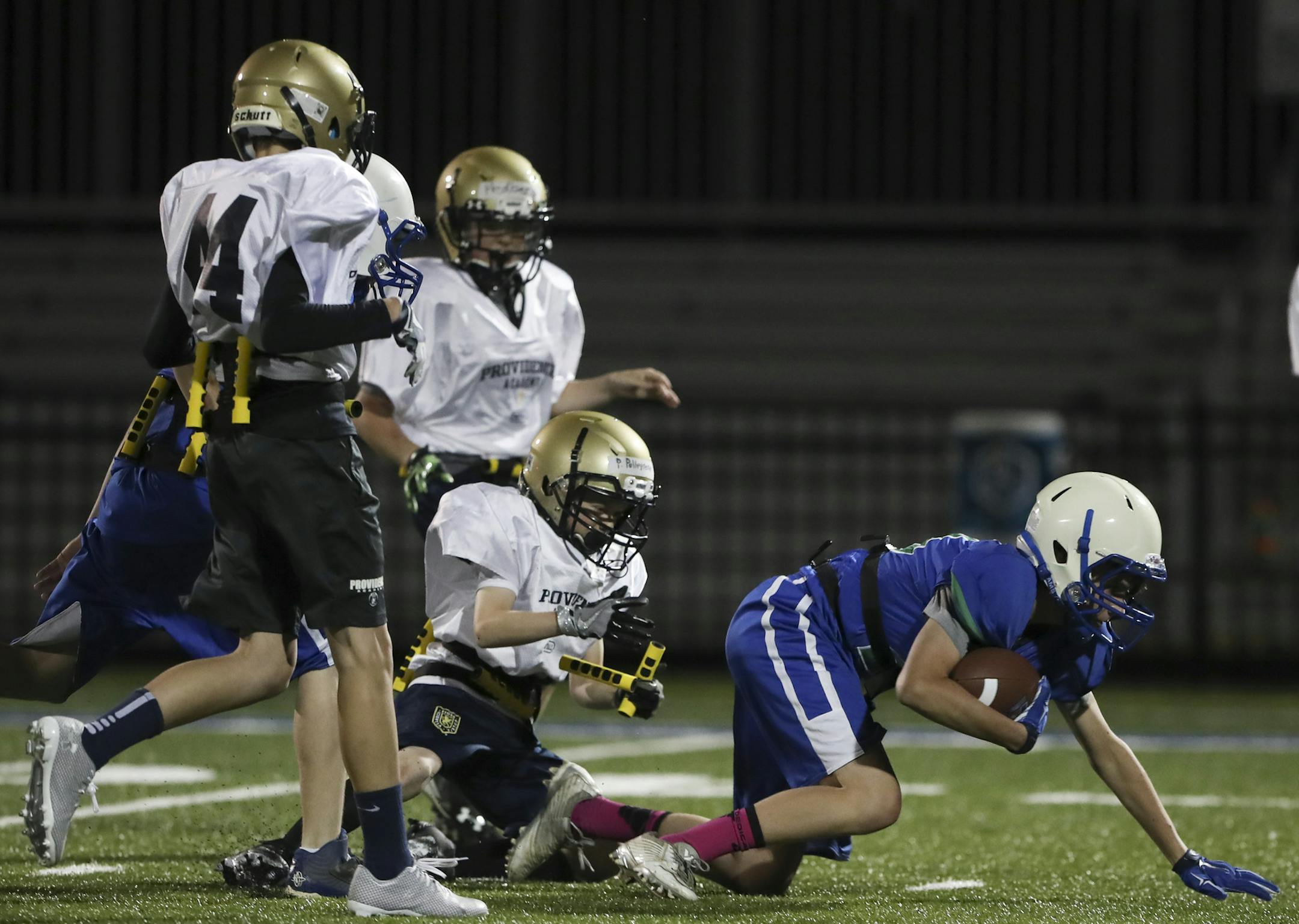 Providence Academy&#x2019;s Paul Pellegrene snatched both bars from Tristan Johnson&#x2019;s back to stop a Blake play Monday night. ] JEFF WHEELER &#x2022; jeff.wheeler@startribune.com The IMAC Conference has begun an initiative to help bring back football to the schools called Fusion Football. It's for middle schoolers and it's basically modified flag football using helmets and shoulder pads. There is no tackling and minimal contact while teaching proper technique so kids are prepared for tack