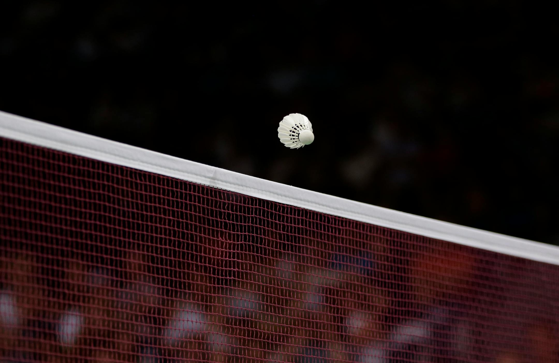 The shuttlecock crosses the net during a men's singles badminton match between Indonesia's Simon Santoso and Estonia's Raul Must at the 2012 Summer Olympics, Sunday, July 29, 2012, in London. (AP Photo/Andres Leighton)