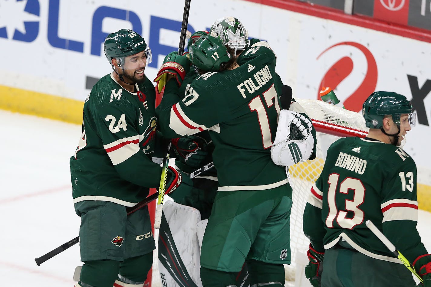 Minnesota Wild's Marcus Foligno (17) hugs teammate Minnesota Wild's goalie Cam Talbot (33) after their 3-2 win over the San Jose Sharks during an NHL hockey game Friday, April 16, 2021, in St. Paul, Minn. (AP Photo/Stacy Bengs)