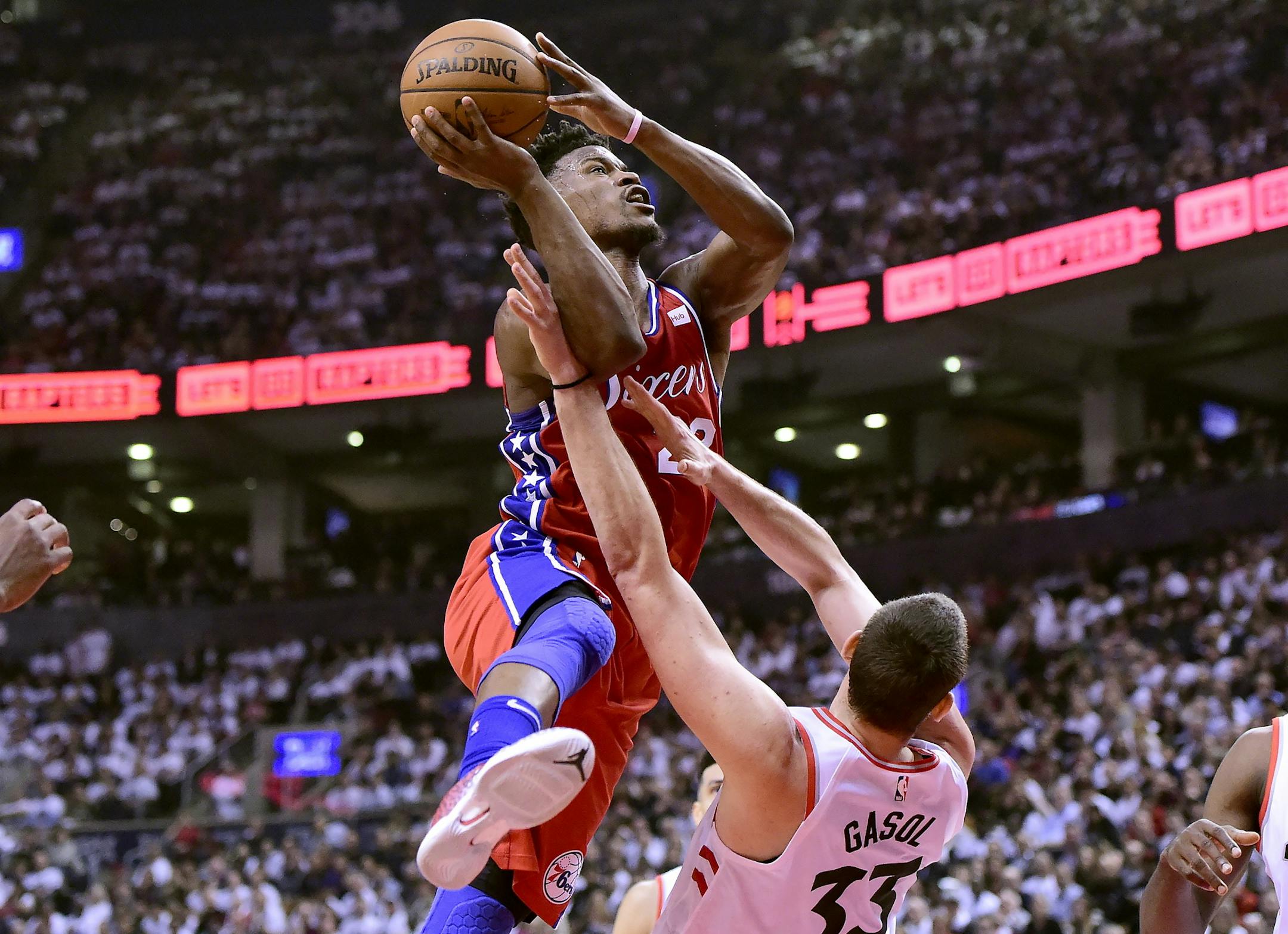 Philadelphia 76ers guard Jimmy Butler (23) drives on Toronto Raptors center Marc Gasol (33) on his way to the basket, during first half NBA Eastern Conference basketball semifinal action in Toronto on Sunday, May 12, 2019. (Frank Gunn/The Canadian Press via AP)