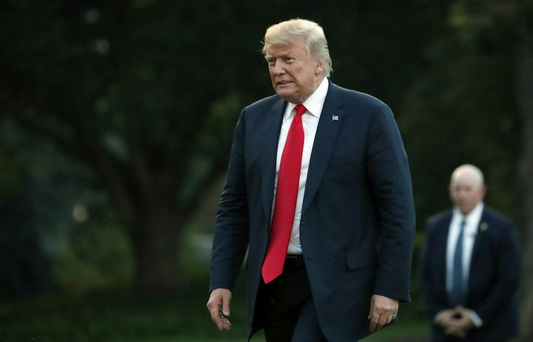 President Donald Trump walks on the South Lawn of the White House after stepping off Marine One, Thursday, July 26, 2018, in Washington. Trump is returning from a trip to Iowa and Illinois.