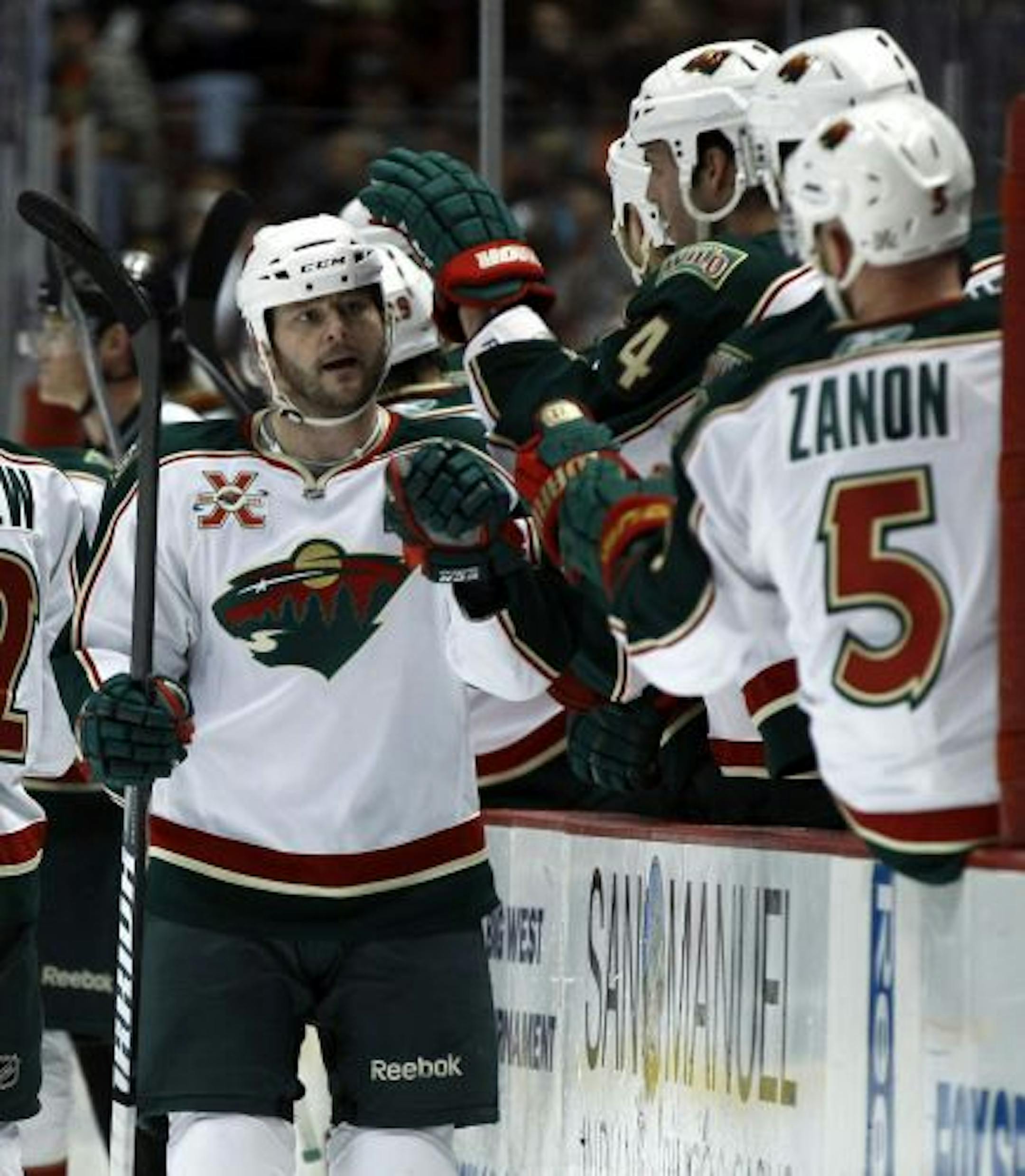 Minnesota Wild center John Madden , left, is congratulated after scoring a goal against the Anaheim Ducks in the first period of an NHL hockey game in Anaheim, Calif., Friday, Feb. 25, 2011.