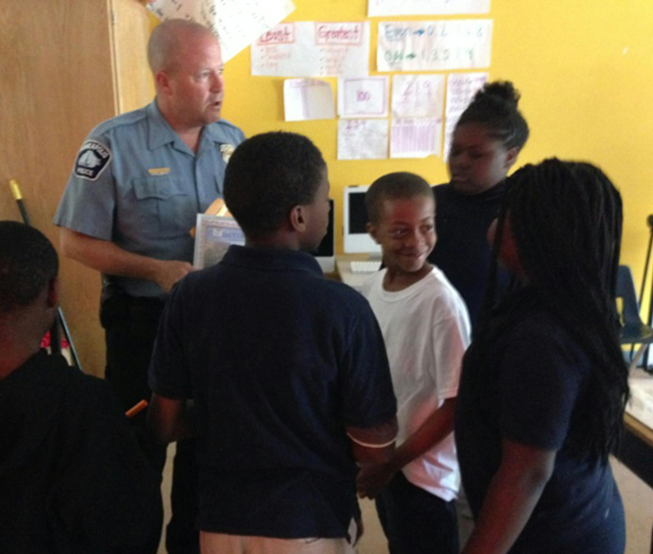 Minneapolis police officer Mike Kirchen with students at Lucy Craft Laney Community School on Thursday, June 5, 2014.