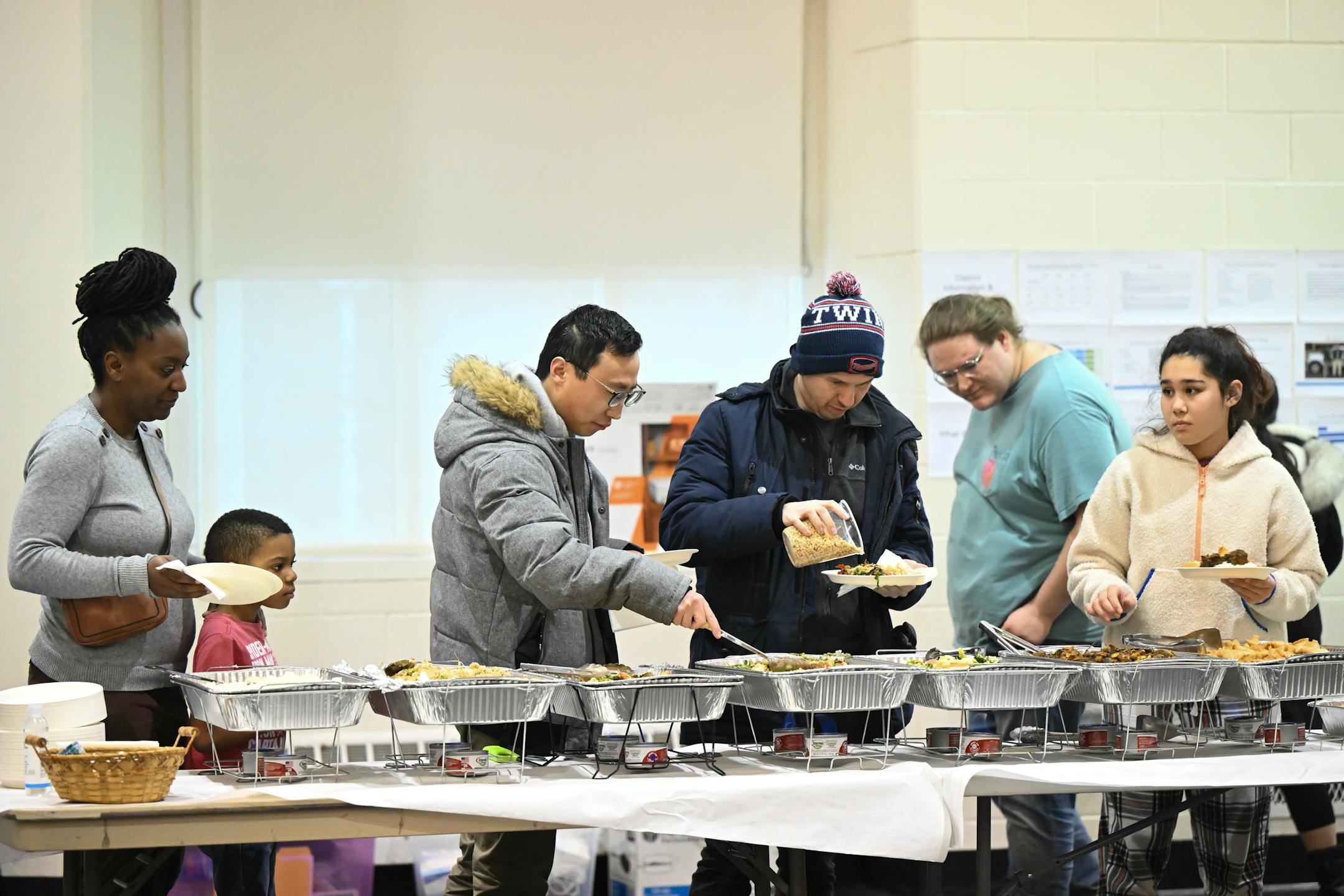 Community members line up for dinner.