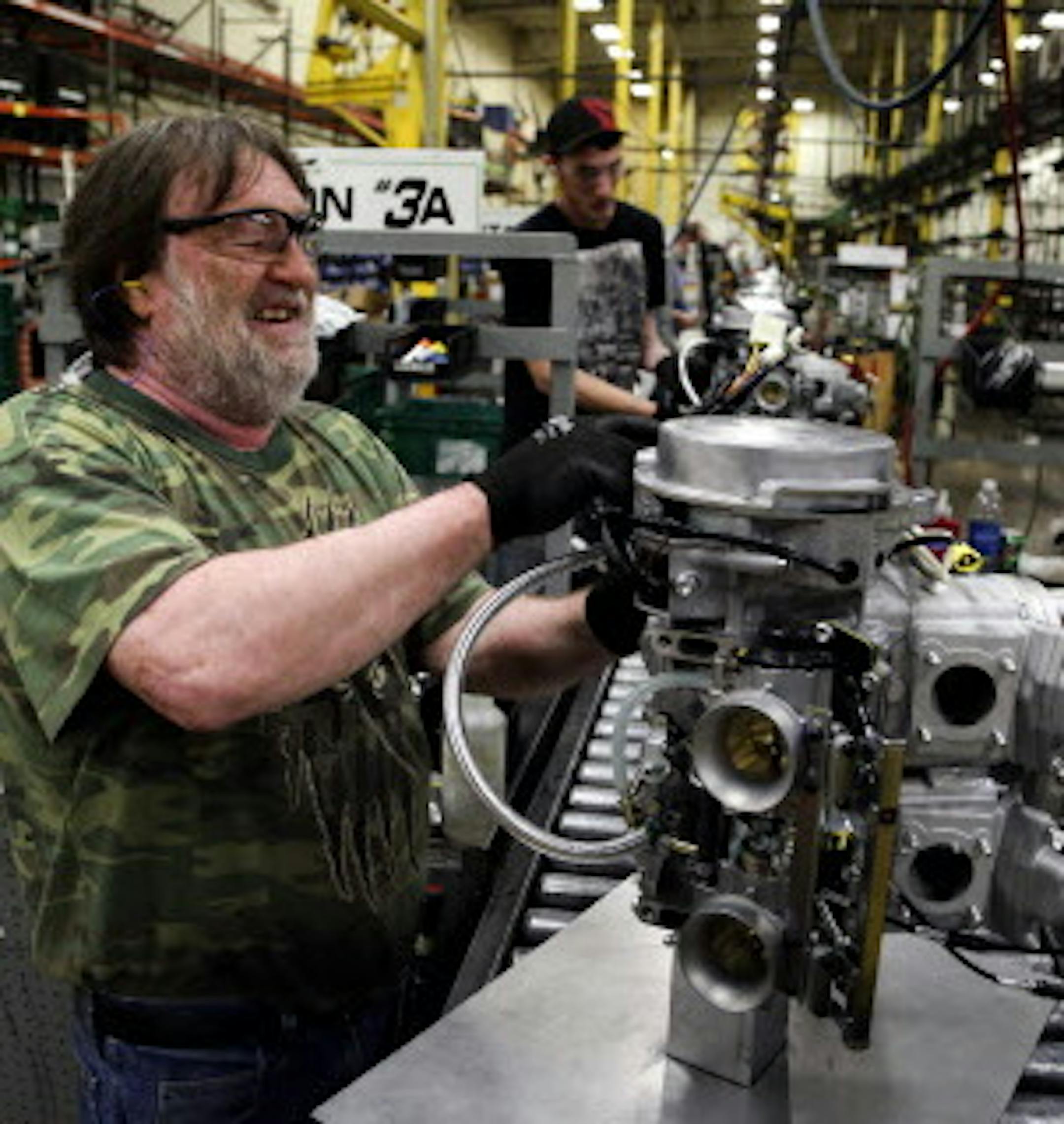 Arctic Cat employee Norman Olson prepares an engine for assembly in the XF 800 Artic Cat snowmobile at Arctic Cat's muanufacturing facility Wednesday, May 15, 2013 in Thief River Falls, MN. The snowmobile giant employs about 1,300 workers in Thief River Falls.](DAVID JOLES/STARTRIBUNE) djoles@startribune Pennington County is an island of growth in a sea of economic contraction in northwest Minnesota. Since 2000, job growth in the county has quadrupled population growth, making it an anomaly both
