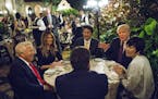 President Donald Trump dines with Prime Minister Shinzo Abe of Japan, center, their spouses Melania Trump and Akie Abe, and Robert Kraft, the New Engl