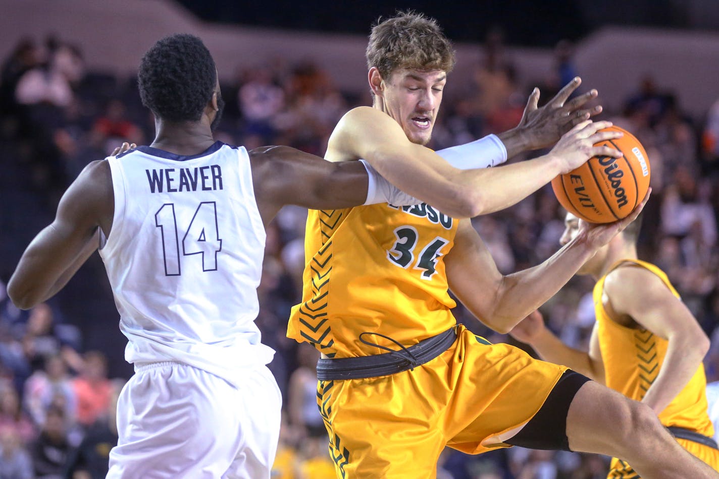 North Dakota State forward Rocky Kreuser (34) grabs a rebound next to Oral Roberts forward DeShang Weaver (14) during an NCAA college basketball game in Tulsa, Okla., on Saturday, Jan. 22, 2022. (Ian Maule/Tulsa World via AP)