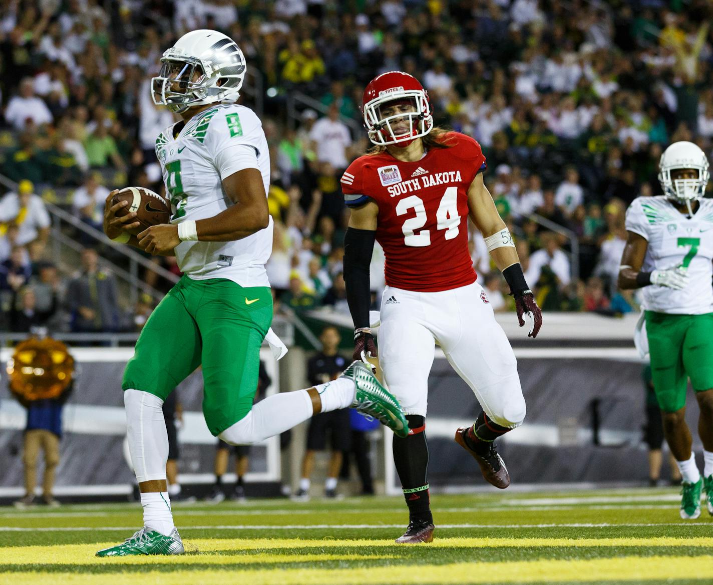 Oregon quarterback Marcus Mariota (8) runs into the end zone for a touchdown during the second quarter of an NCAA college football game against South Dakota in Eugene, Ore., Saturday, Aug. 30, 2014. (AP Photo/Ryan Kang) ORG XMIT: MIN2014090418534832