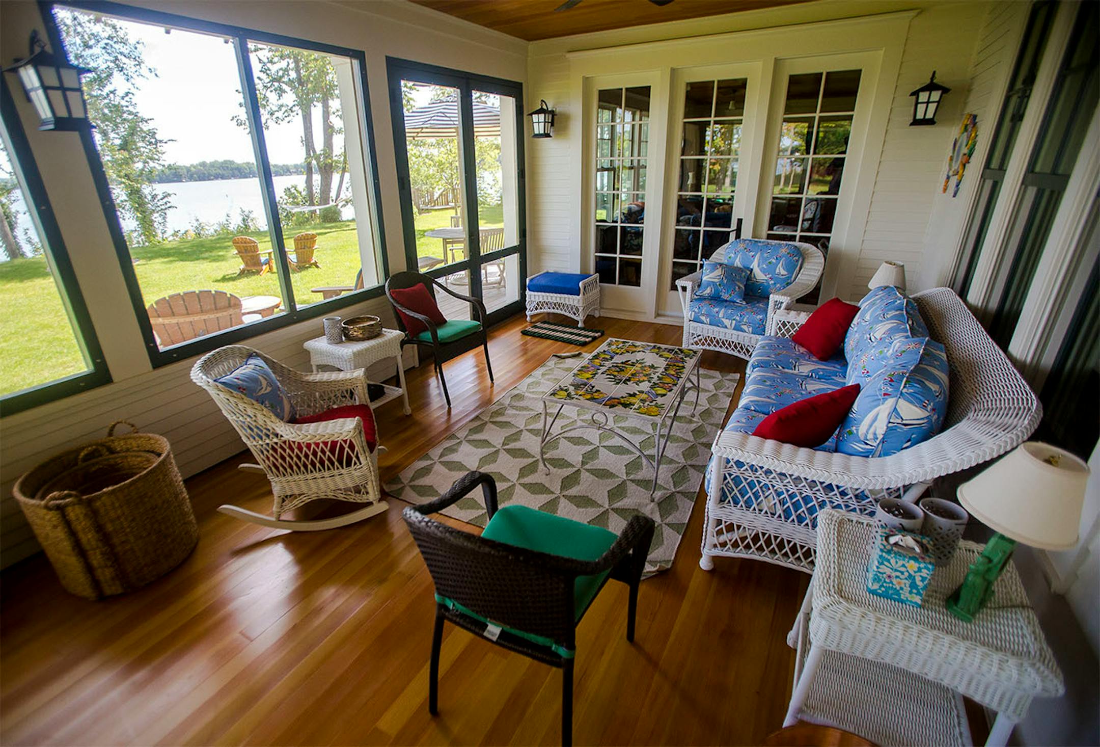The old-fashioned wraparound porch boasts a fir floor and ceiling and nautical-themed furnishings.
Glass-paned door opens to the living room.