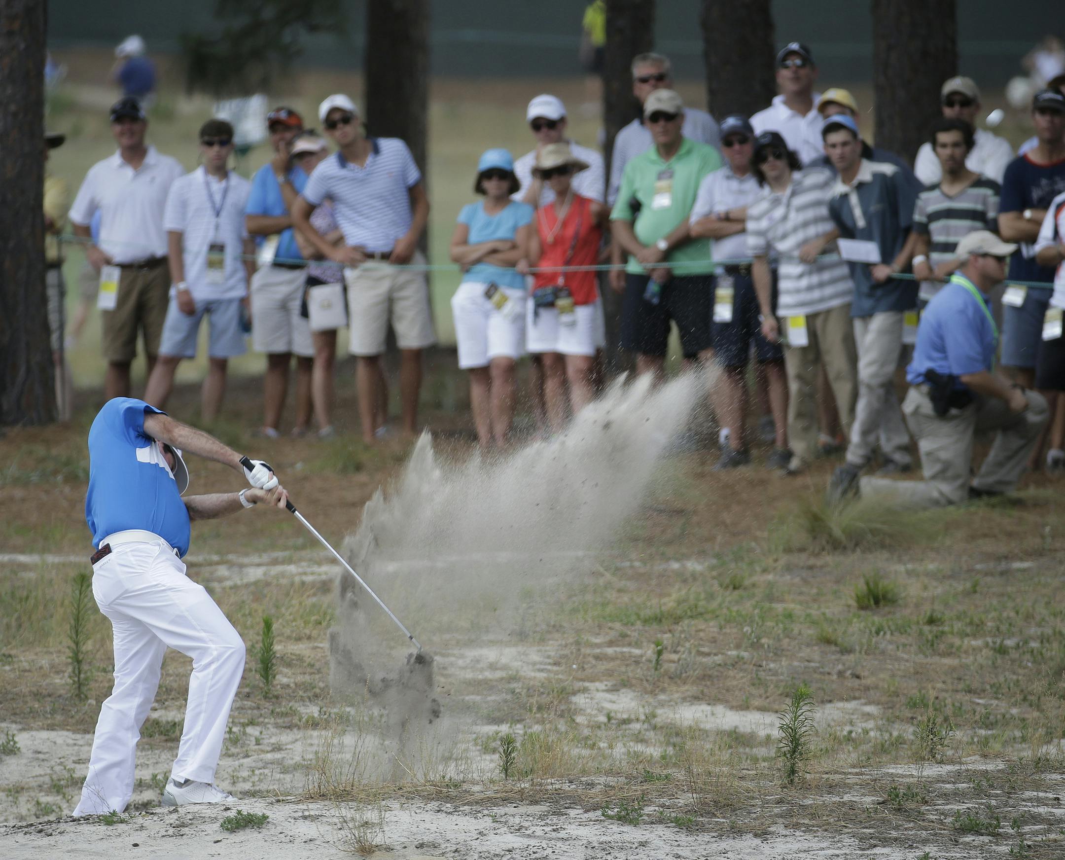 Bubba Watson hits out of the native area on the fourth hole during the first round of the U.S. Open golf tournament in Pinehurst, N.C., Thursday, June 12, 2014. (AP Photo/Eric Gay)
