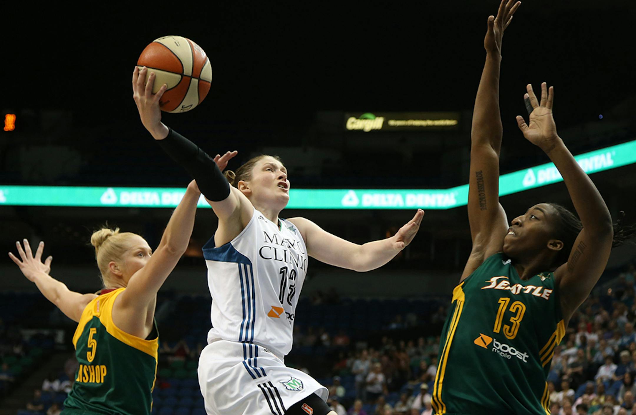 Lynx Lindsay Whalen got fouled by Seattle's Abby Bishop on her way to the basket during the first half.