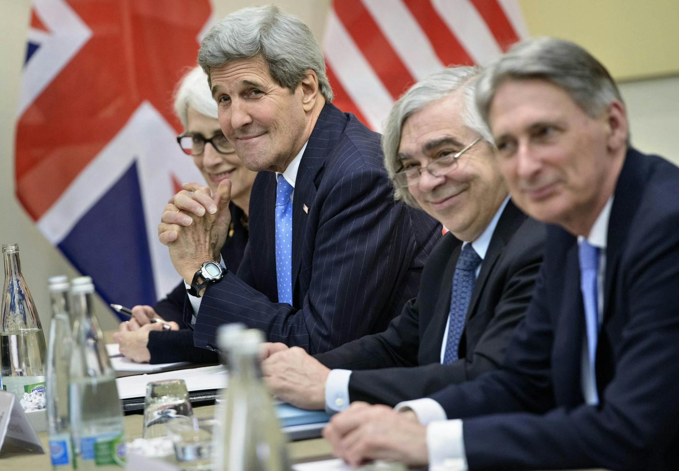 From left, US Under Secretary for Political Affairs Wendy Sherman, US Secretary of State John Kerry, US Secretary of Energy Ernest Moniz and British Foreign Secretary Philip Hammond wait for a meeting at the Beau Rivage Palace Hotelin Lausanne, Switzerland, Sunday March 28, 2015. Iran is considering demands for further cuts to its uranium enrichment program but is pushing back on how long it must limit technology it could use to make atomic arms, Western officials involved in the nuclear talks s
