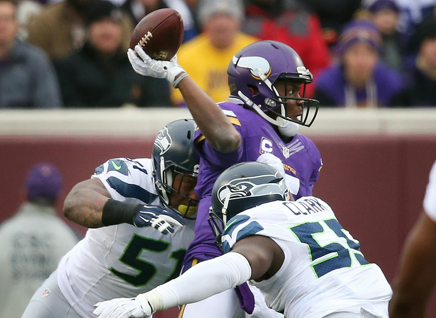 Minnesota Vikings quarterback Teddy Bridgewater (5) was pressured into throwing an incomplete pass by Seattle Seahawks outside linebacker Bruce Irvin (51) and defensive end Frank Clark (55) Sunday December 6, 2015 in Minneapolis, MN.