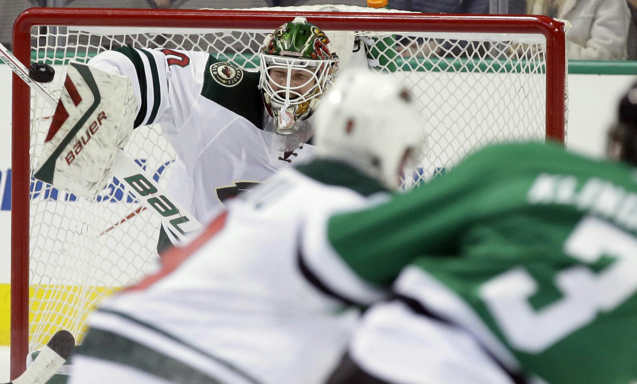 Minnesota Wild goalie Devan Dubnyk (40) blocks a shot during the first period of an NHL hockey game against the Dallas Stars Saturday, Jan. 9, 2016, in Dallas. (AP Photo/LM Otero)