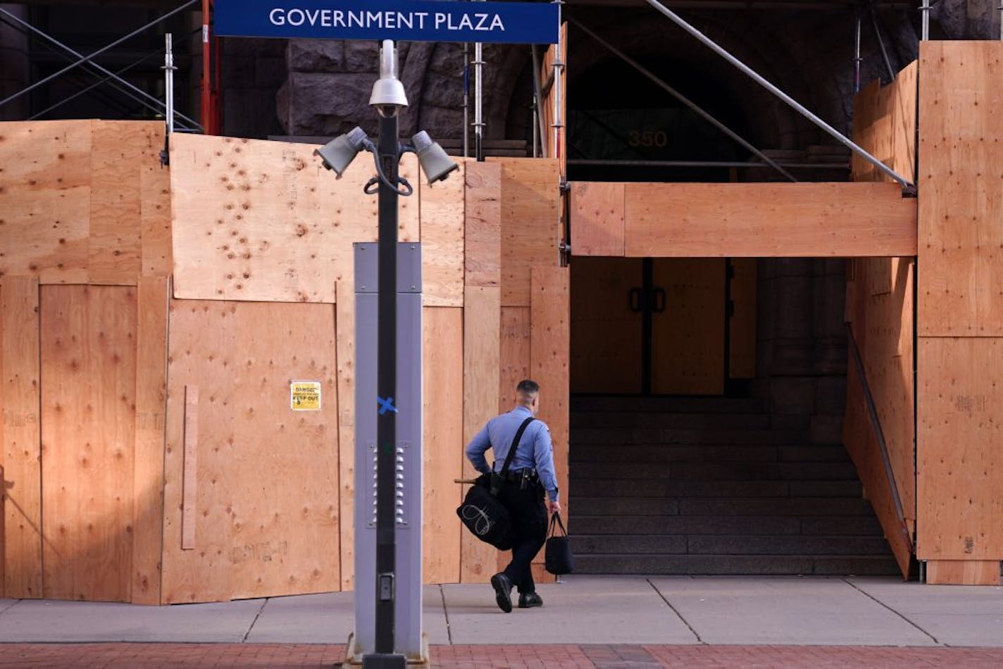 A lone Minneapolis Police officer walked to City Hall with a bag of riot gear as news circulated that Democratic Presidential candidate Joe Biden was pulling ahead of President Donald Trump and was poised to become the President-Elect Friday morning.