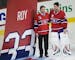 Former Montreal Canadiens goalie Patrick Roy, left, stands with Canadiens goalie Carey Price as a banner is raised during a ceremony retiring Roy's je