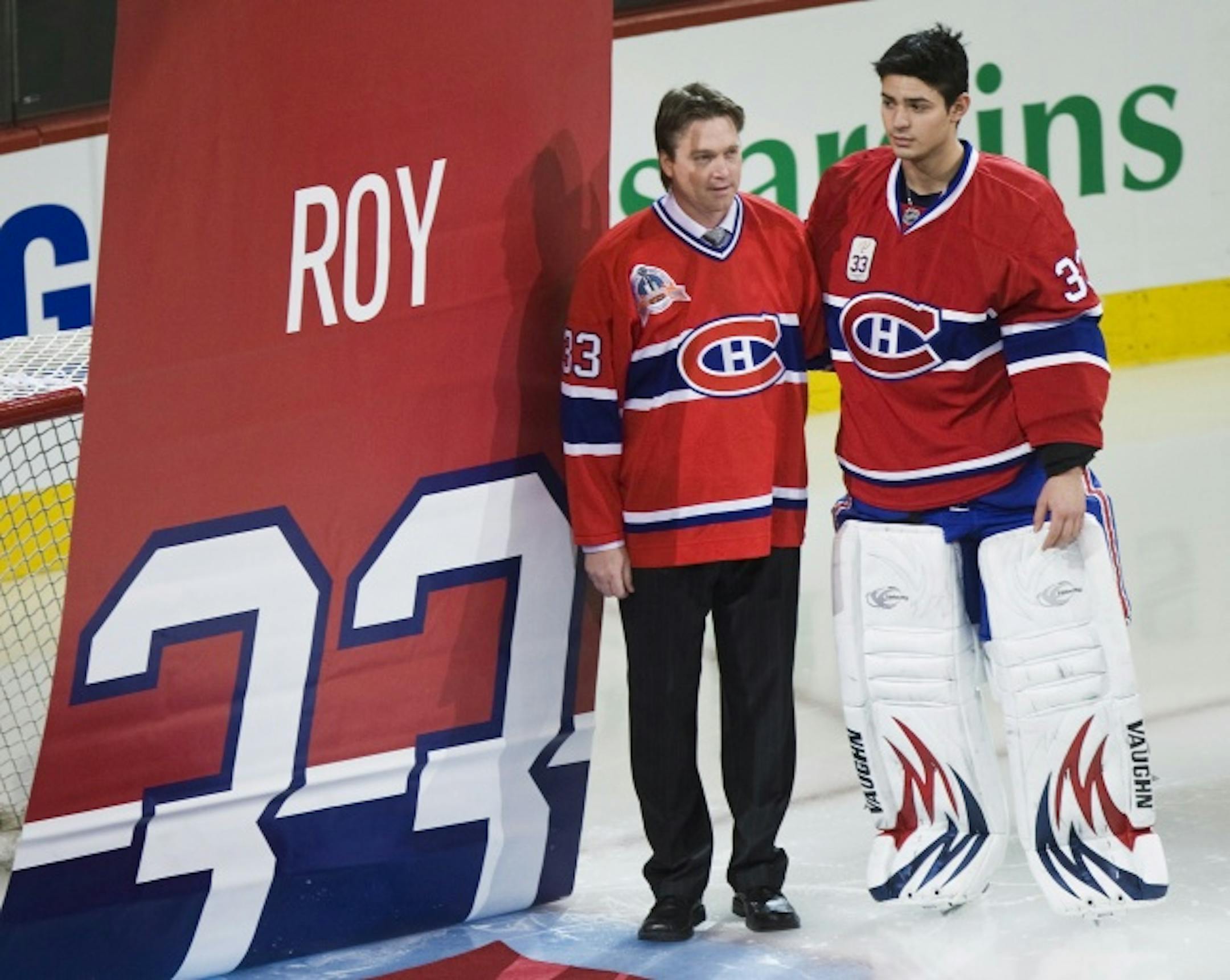 Former Montreal Canadiens goalie Patrick Roy, left, stands with Canadiens goalie Carey Price as a banner is raised during a ceremony retiring Roy's jersey No. 33 on Nov. 22, 2008.