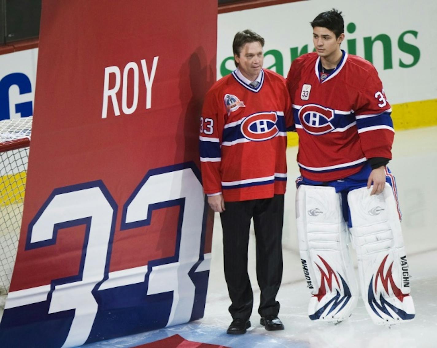 Former Montreal Canadiens goalie Patrick Roy, left, stands with Canadiens goalie Carey Price as a banner is raised during a ceremony retiring Roy's jersey No. 33 on Nov. 22, 2008.