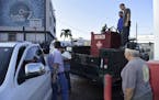 Department of Education employees fill a generator with diesel in San Juan, Puerto Rico, Thursday, Sept. 22, 2016, after a massive blackout hit Puerto