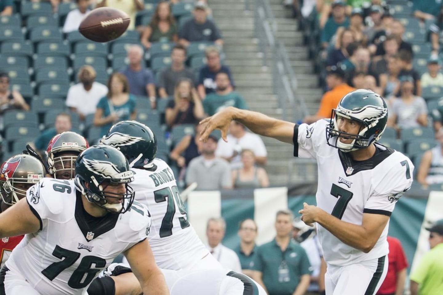 Philadelphia Eagles quarterback Sam Bradford (7) throws the ball as guard/tackle Allen Barbre (76) gets into position during the first half of a the preseason NFL football game, Thursday, Aug. 11, 2016, in Philadelphia.